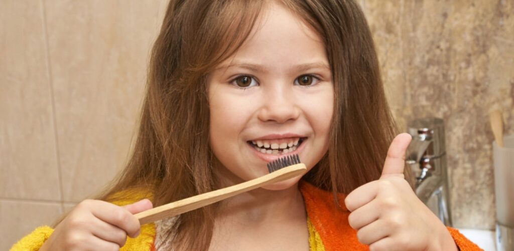 Girl with bamboo toothbrush 1