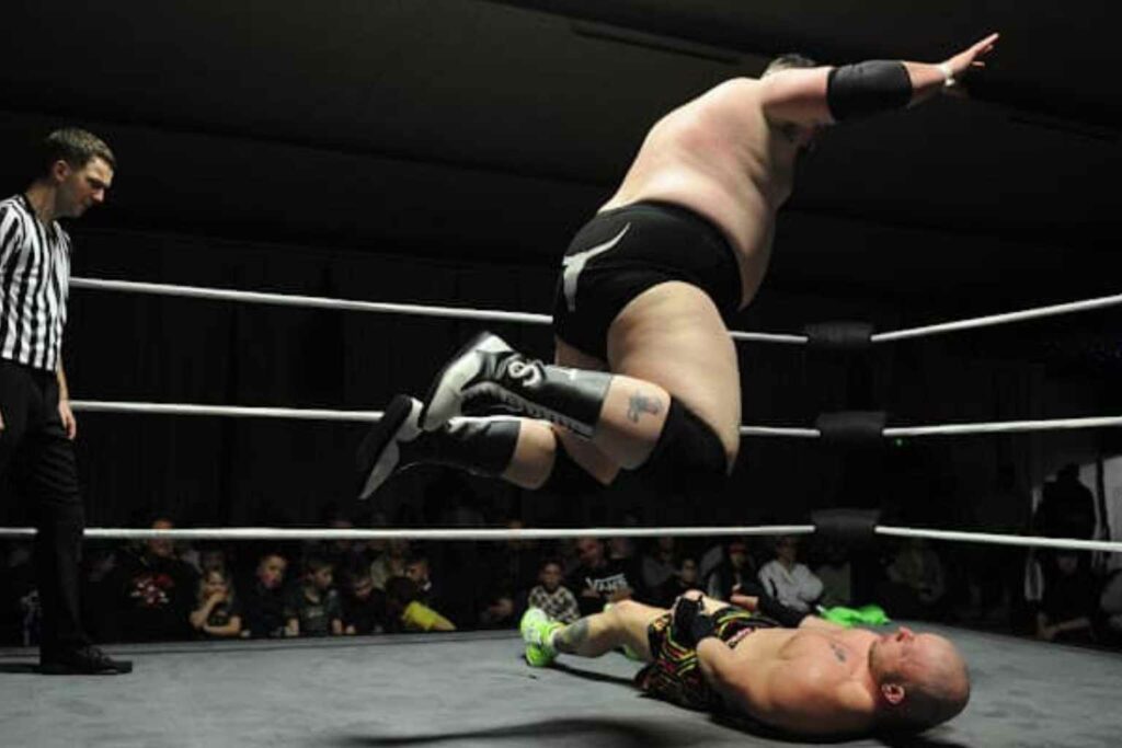 Wrestler Tim Strange about to land on a very unfortunate opponent